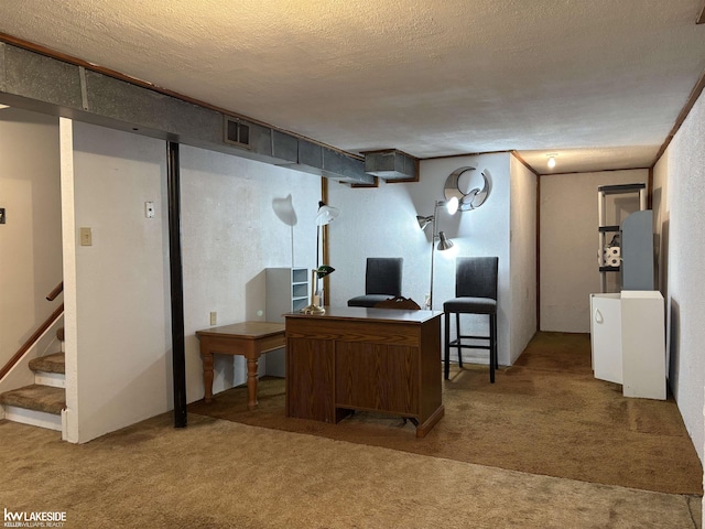 home office featuring a textured ceiling and carpet