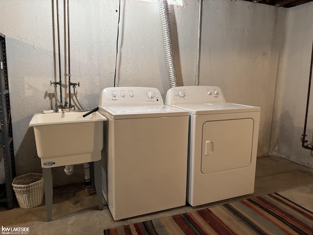 laundry room featuring washing machine and dryer and sink