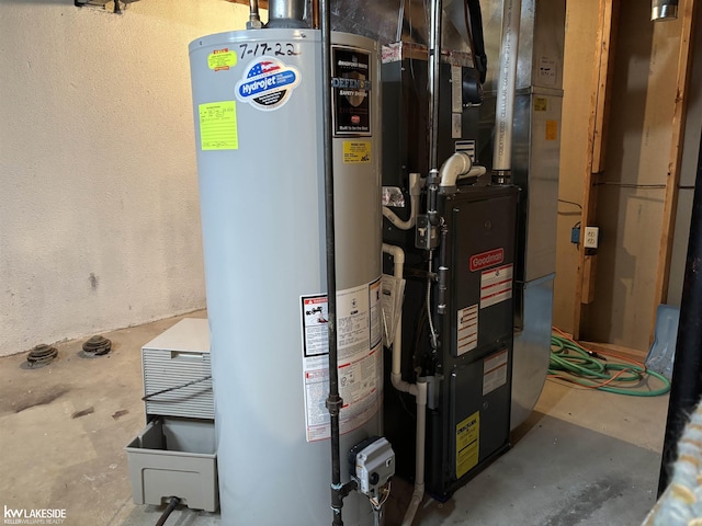 utility room featuring water heater and heating unit