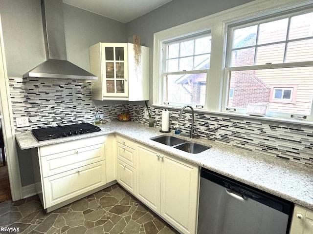 kitchen with dishwasher, wall chimney range hood, decorative backsplash, black gas cooktop, and sink