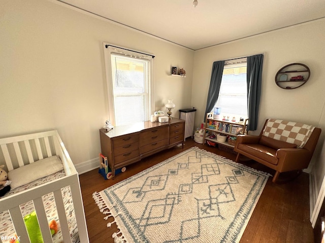 living area featuring plenty of natural light and dark hardwood / wood-style floors