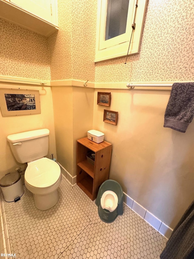 bathroom with toilet and tile patterned floors