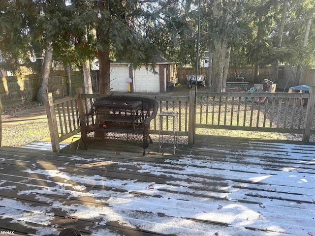 deck with a garage and an outbuilding