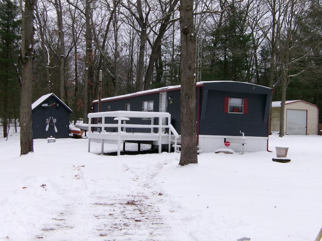 view of front facade featuring a garage and an outbuilding