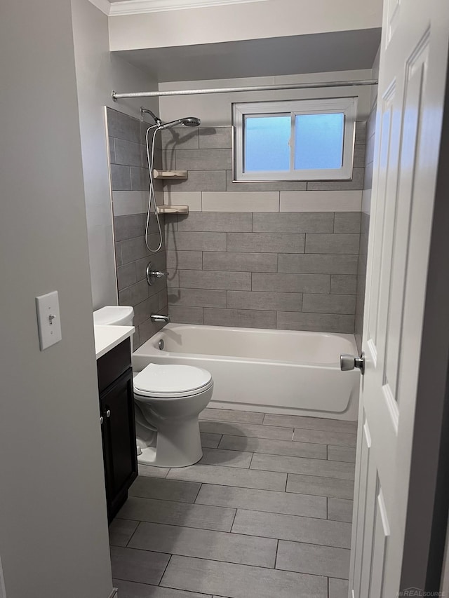 full bathroom featuring tiled shower / bath combo, vanity, and toilet