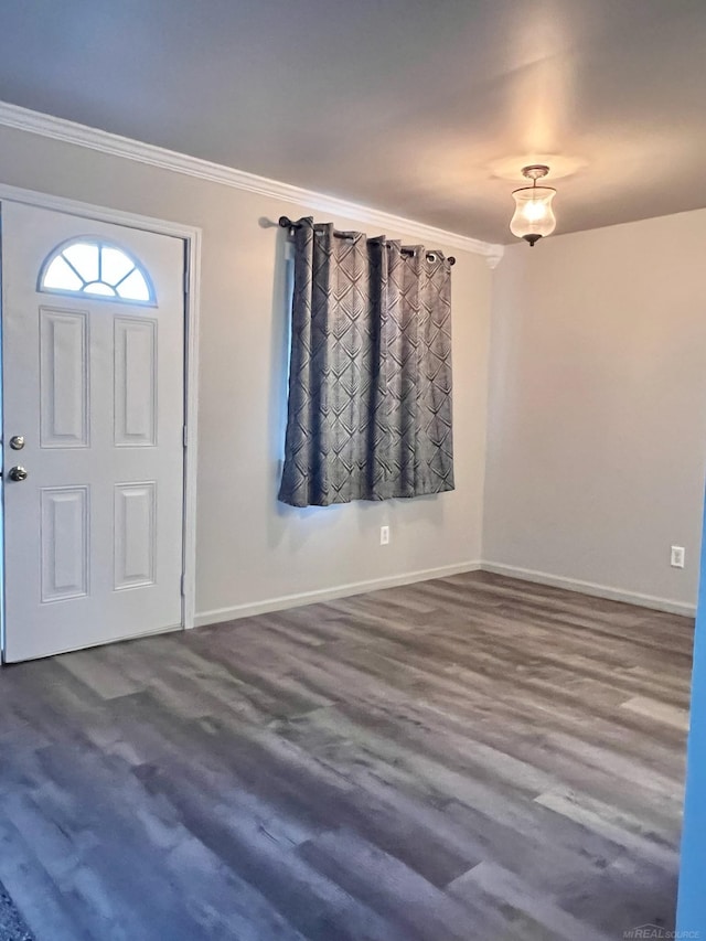 entryway with ornamental molding and hardwood / wood-style floors