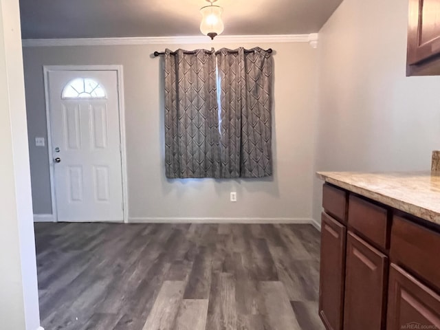 foyer entrance featuring crown molding and dark hardwood / wood-style floors