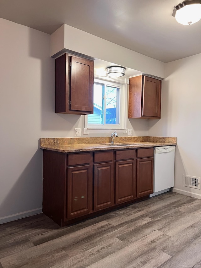 kitchen with sink, hardwood / wood-style floors, dishwasher, and dark brown cabinets