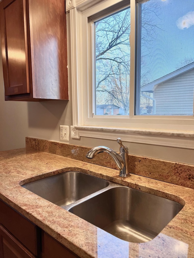 details featuring sink and light stone countertops