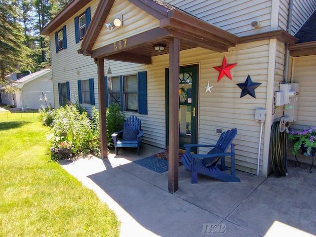 entrance to property featuring a lawn