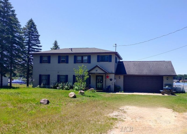 view of front of home featuring a front yard and a garage