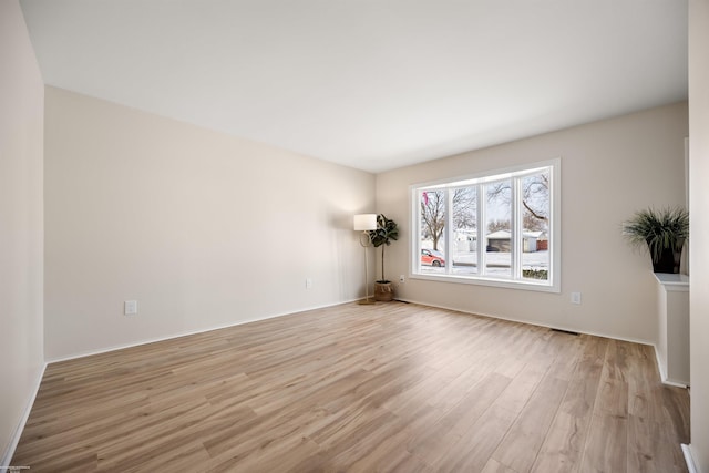 unfurnished room with light wood-type flooring