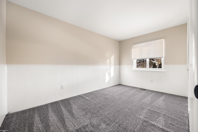 unfurnished room featuring carpet flooring