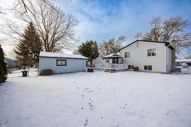 snow covered rear of property with a gazebo