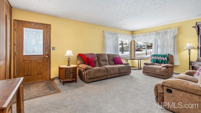 carpeted living room featuring a textured ceiling