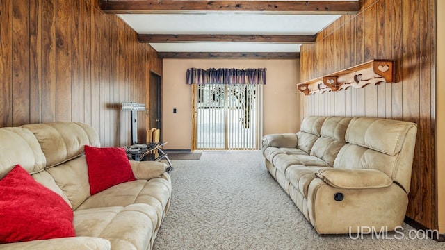 carpeted living room with wooden walls and beam ceiling