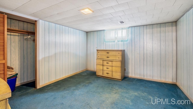 unfurnished bedroom featuring a closet and dark colored carpet