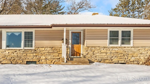 view of snow covered property entrance