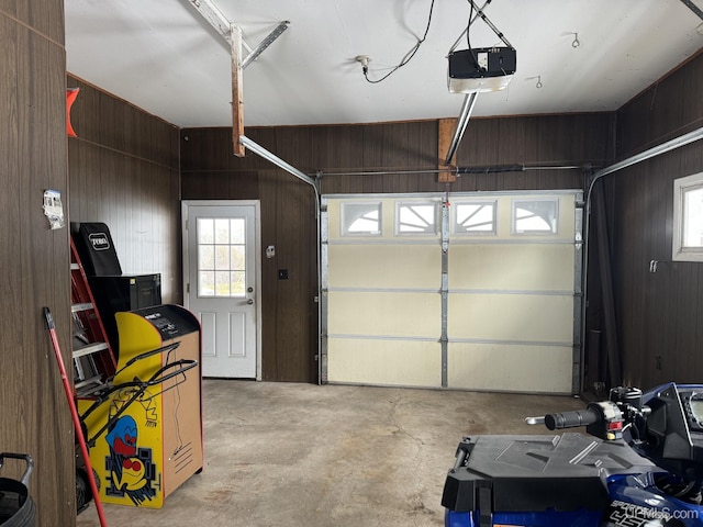 garage with wooden walls and a garage door opener