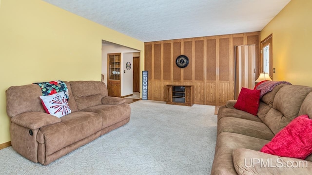 carpeted living room with a textured ceiling