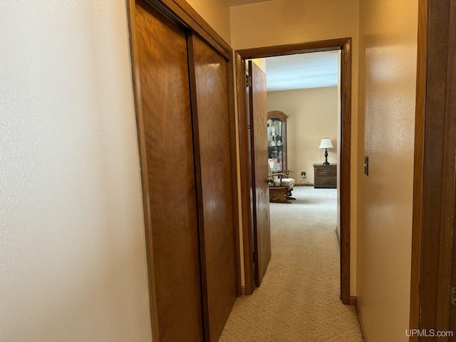 hall with light colored carpet