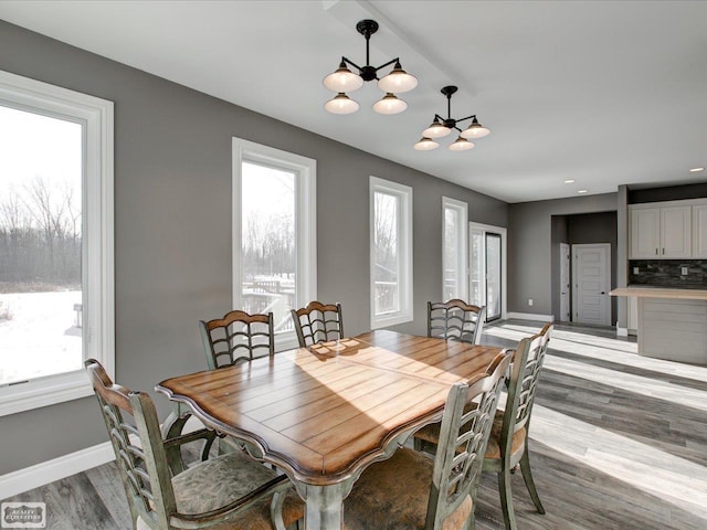 dining area featuring a notable chandelier and light wood-type flooring