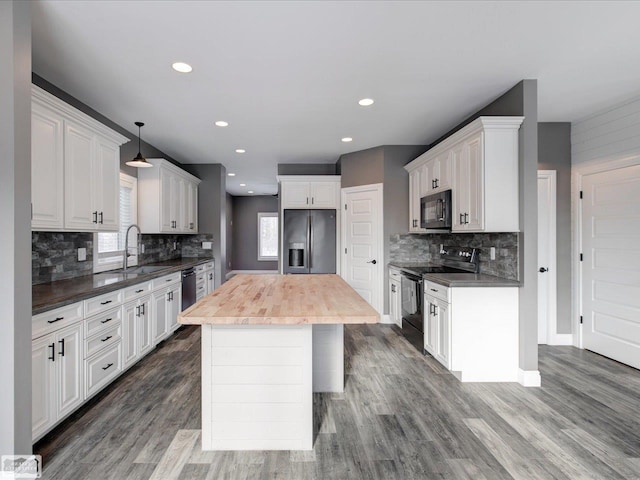 kitchen featuring pendant lighting, white cabinets, and black appliances