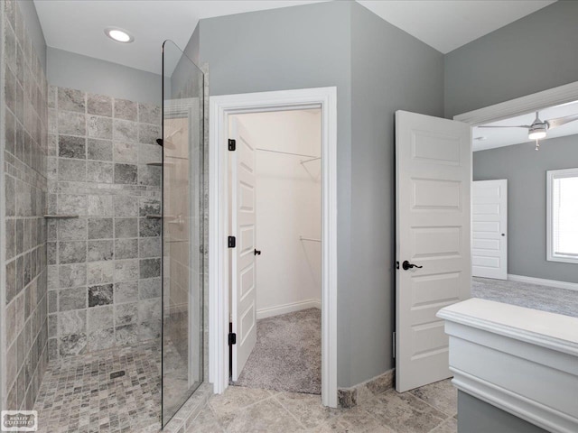 bathroom featuring ceiling fan and tiled shower