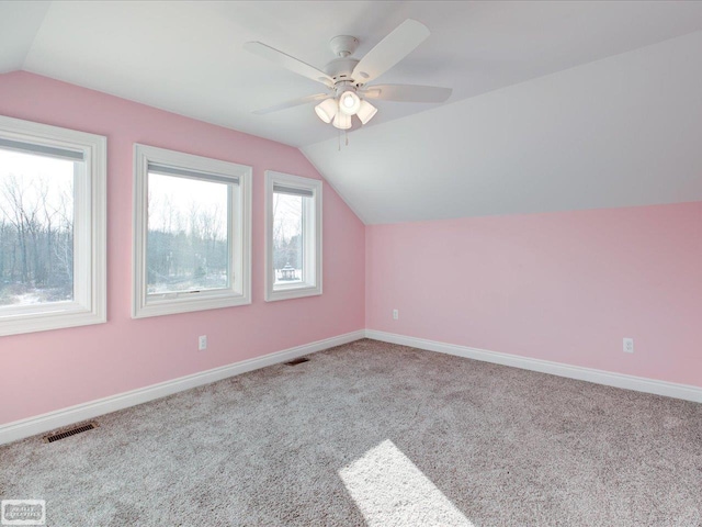 bonus room featuring ceiling fan, lofted ceiling, and light colored carpet