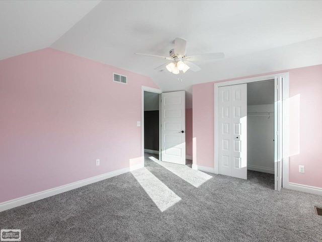 unfurnished bedroom with ceiling fan, lofted ceiling, carpet floors, and a closet