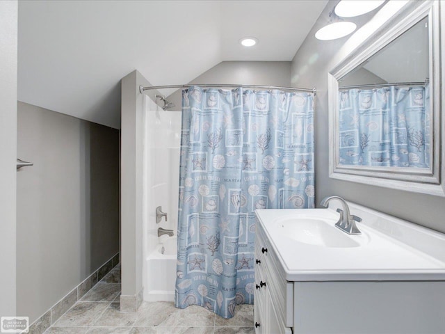 bathroom featuring vanity, lofted ceiling, and shower / bath combination with curtain