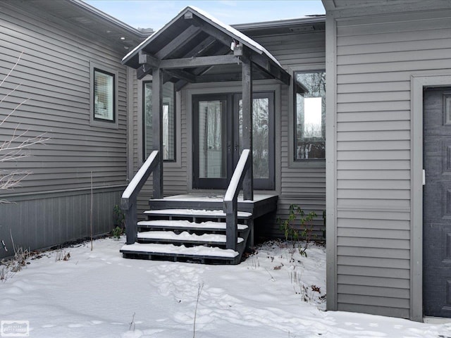 view of snow covered property entrance