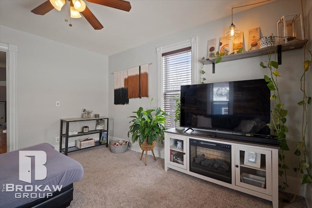 carpeted living room featuring ceiling fan