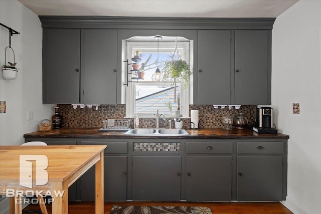 kitchen featuring decorative backsplash, gray cabinetry, and sink