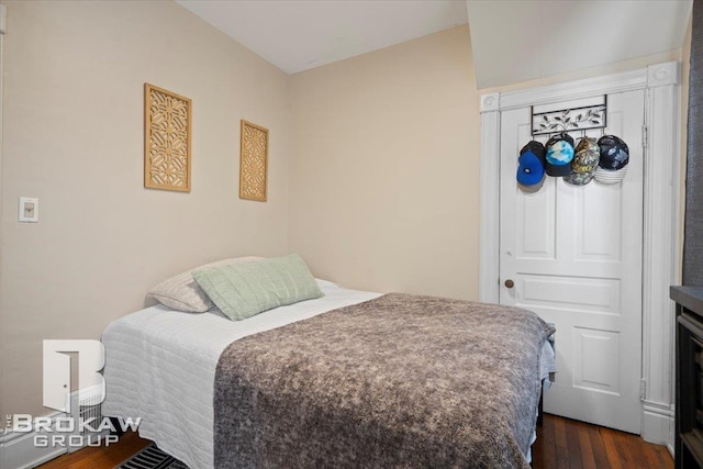 bedroom with dark wood-type flooring