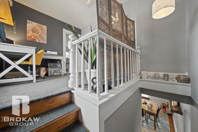 stairs featuring a towering ceiling