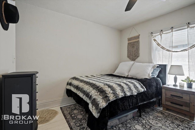 tiled bedroom with ceiling fan