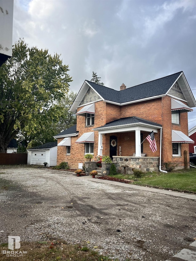 view of front facade with an outbuilding and a garage