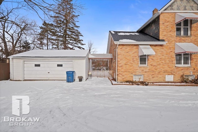 view of snowy exterior featuring a garage