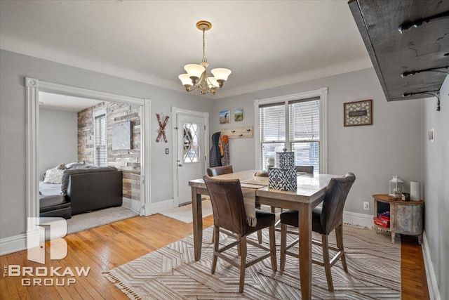 dining space with an inviting chandelier and hardwood / wood-style floors