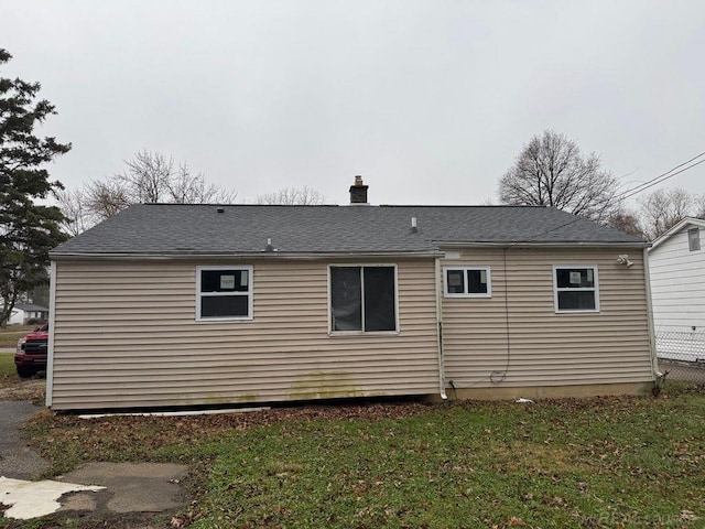 rear view of house with a lawn