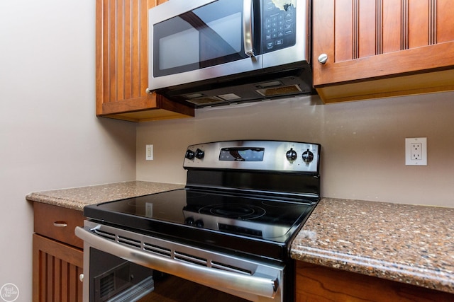 kitchen featuring light stone countertops and appliances with stainless steel finishes