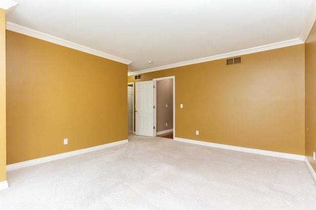 carpeted spare room featuring crown molding