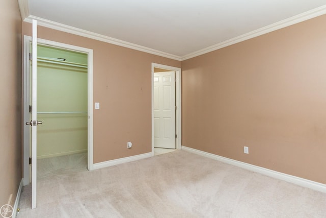 unfurnished bedroom featuring ornamental molding, a closet, and light carpet