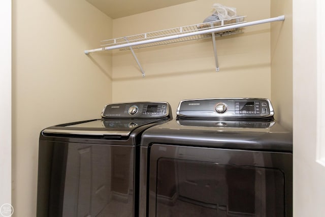 clothes washing area featuring independent washer and dryer