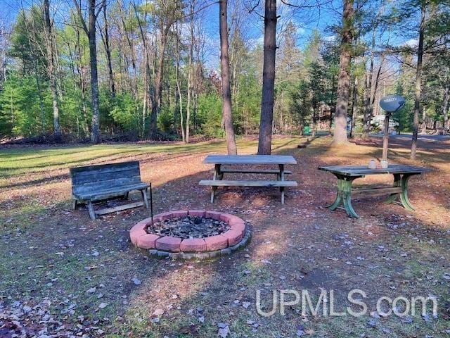 view of property's community with an outdoor fire pit