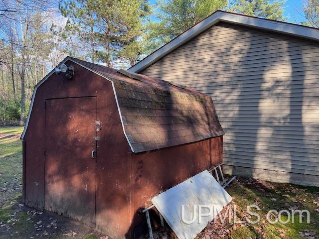 view of home's exterior featuring a storage shed