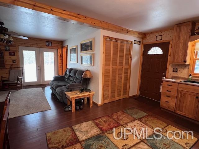 living room with french doors and dark hardwood / wood-style floors