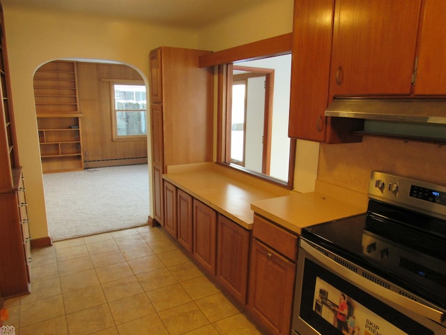 kitchen featuring baseboard heating, stainless steel electric stove, and light colored carpet