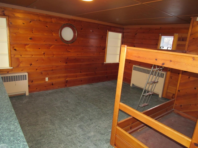 interior space with radiator and wooden walls